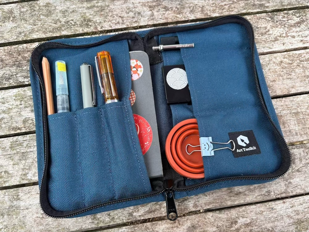 Travel sketching kit components breakdown showing portable watercolour palette and tools