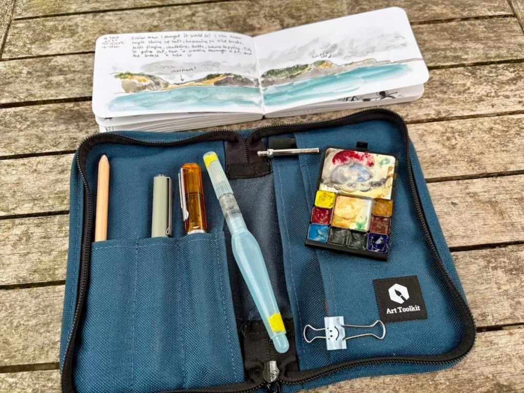 Complete travel sketching kit with portable watercolour palette and finished plein air sketch